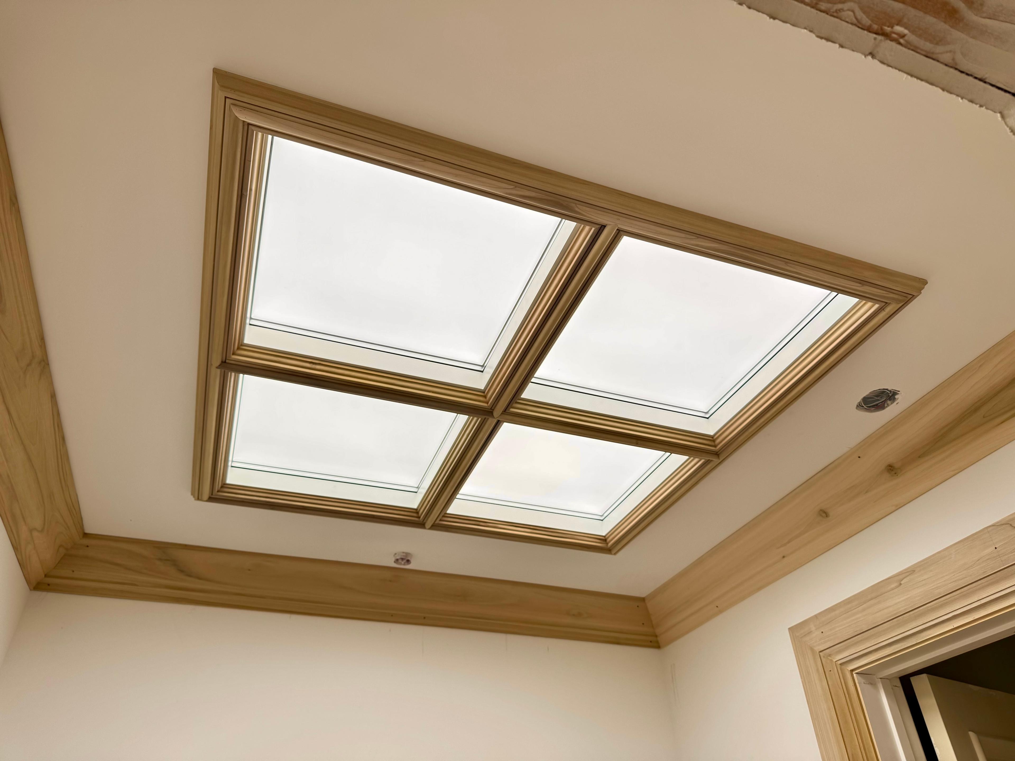 Circadian Sky 2x2 array recessed into a wood-trimmed ceiling opening, simulating a skylight with bright daylight