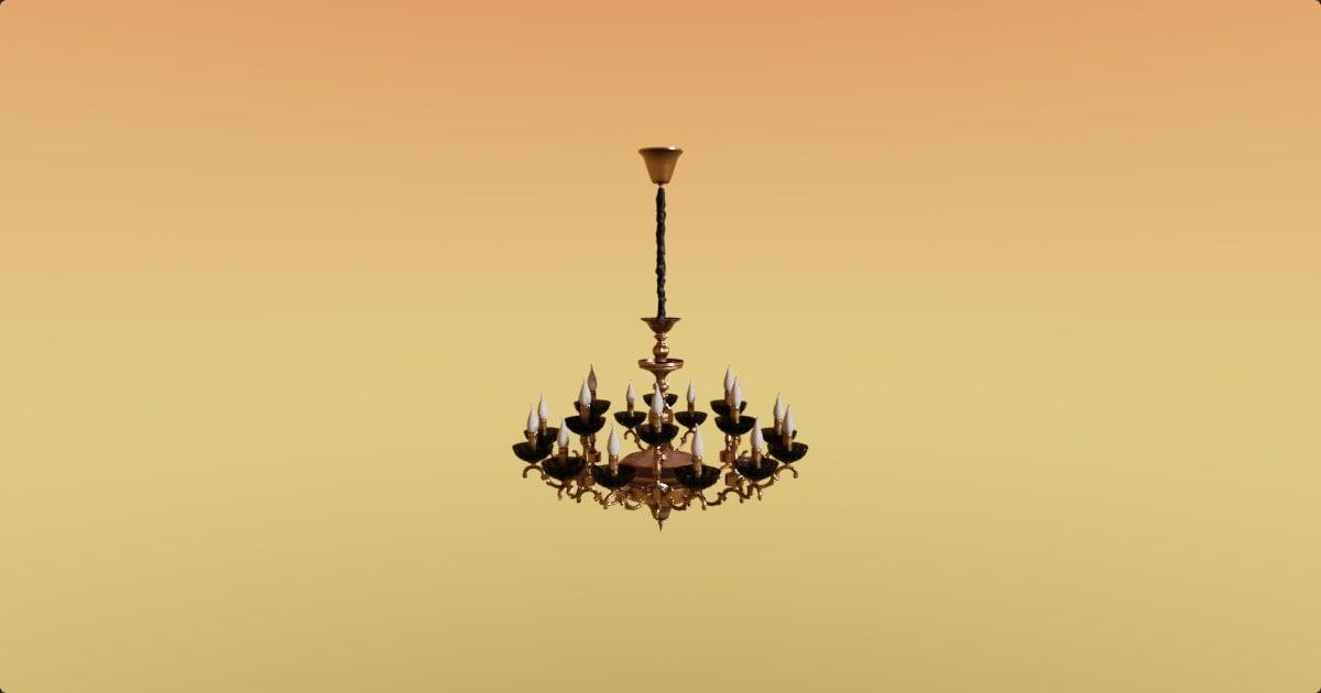 A brass chandelier against a warm golden gradient