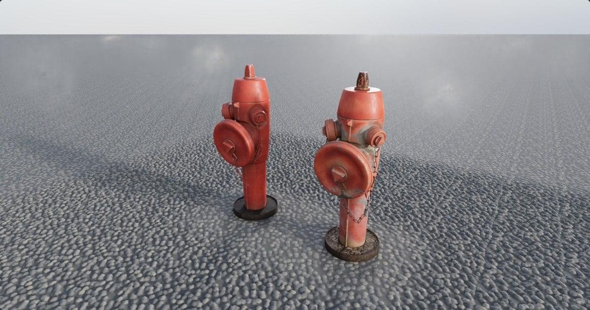 Two red fire hydrants on fine gravel under a pale sky