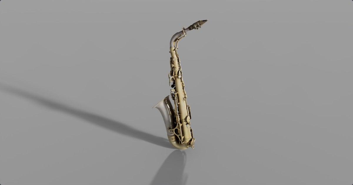An alto saxophone on a gray studio floor with a long shadow